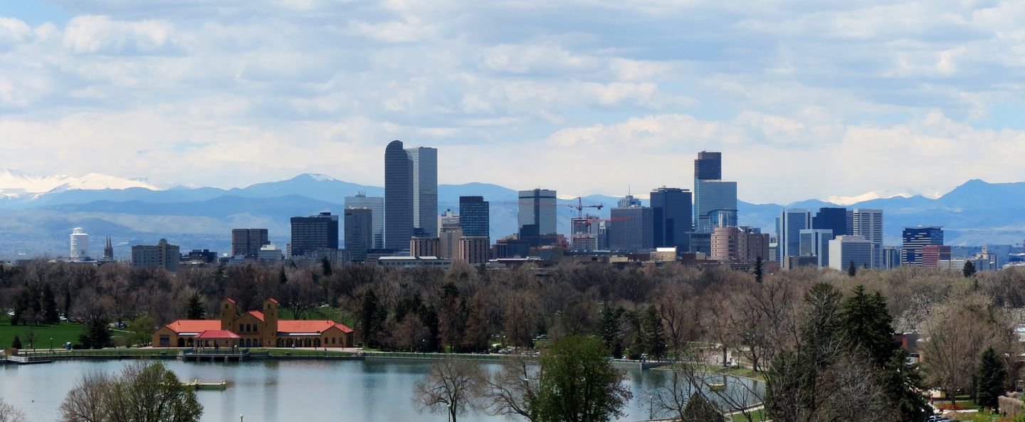Downtown Denver skyline and the Rocky Mountains seen across Ferril Lake in City Park